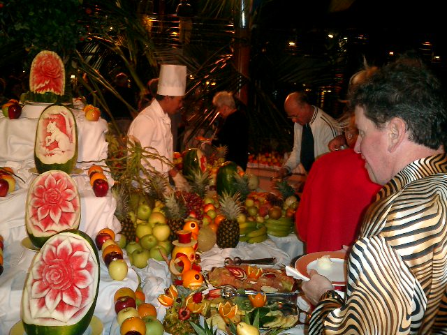 Steve admires the lovely carved watermelons. Click to display the image.
