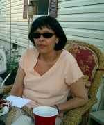 Debbie enjoys a drink. Click to display the image.